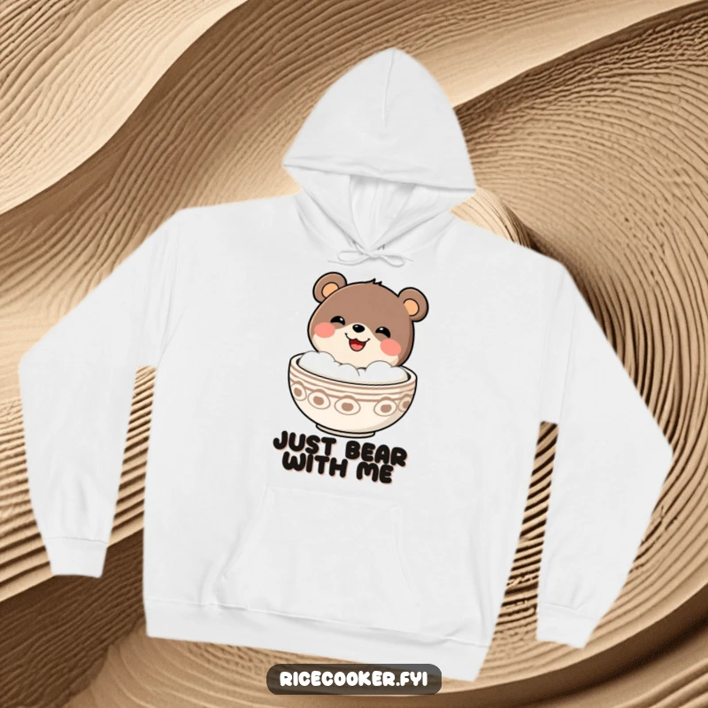 Funny cheerful bear with a grin popping out of a steaming bowl, depicted on a soft and warm hoodie.