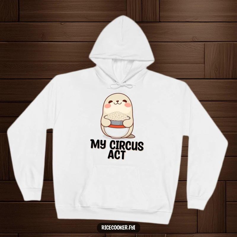 Funny hoodie with a smiling seal balancing a bowl of rice on its nose, offering warmth and a good dose of humor.