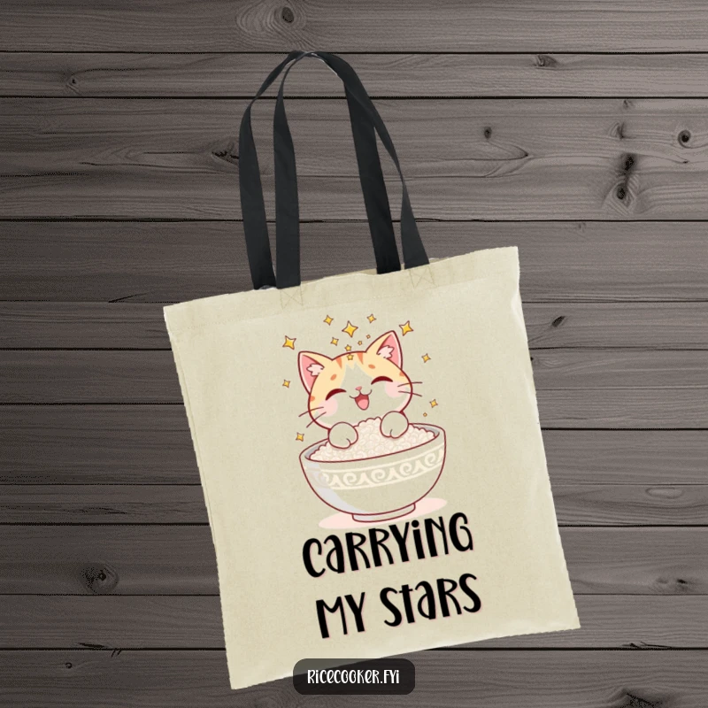 Funny tote bag showcasing a delighted cat sprinkling shimmering stars onto a fresh bowl of cooked rice, a magical sight.
